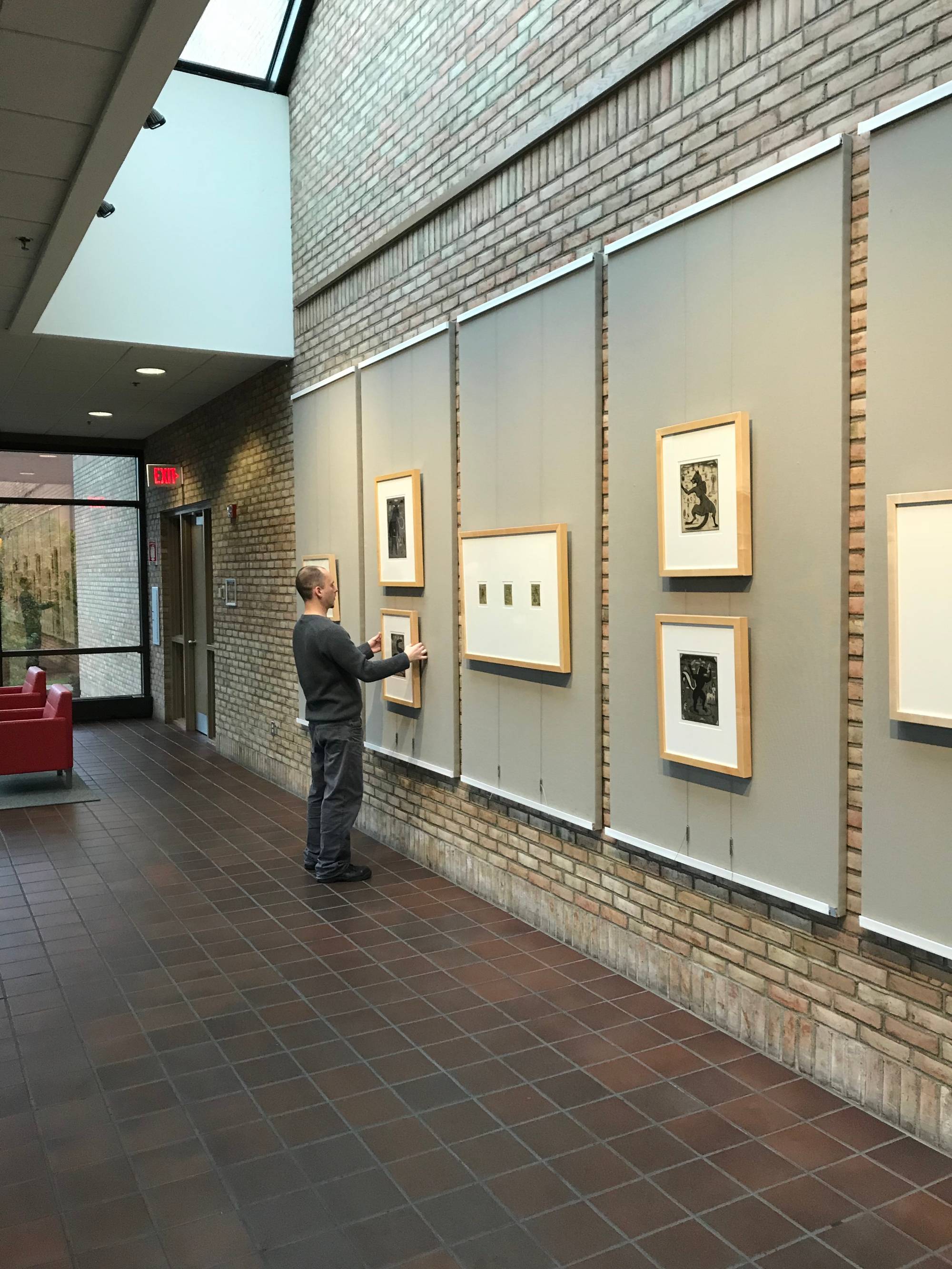 Dru King, GVSU Art Gallery Preparator, installing artwork on campus